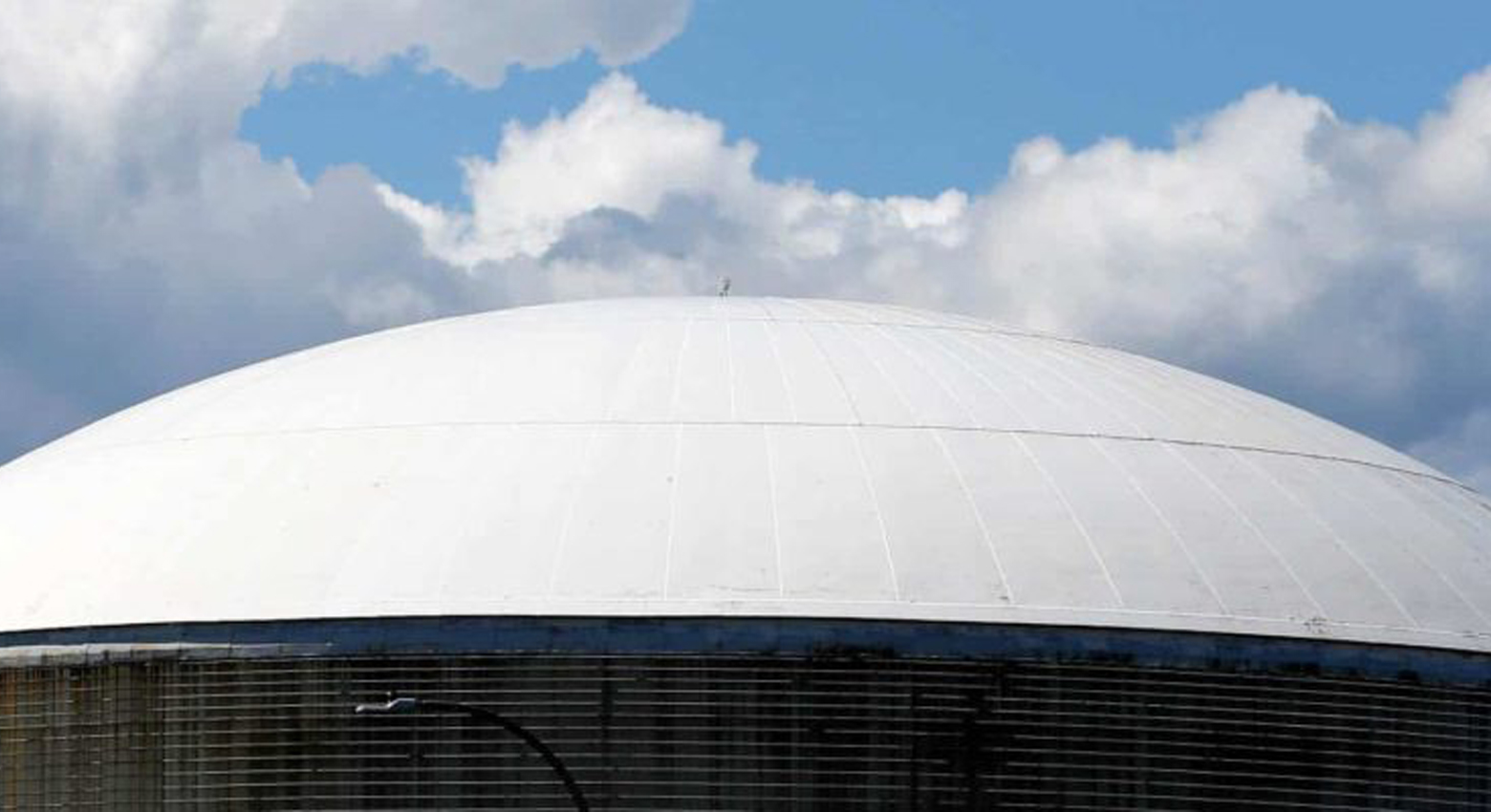 Sky with clouds over round structure 