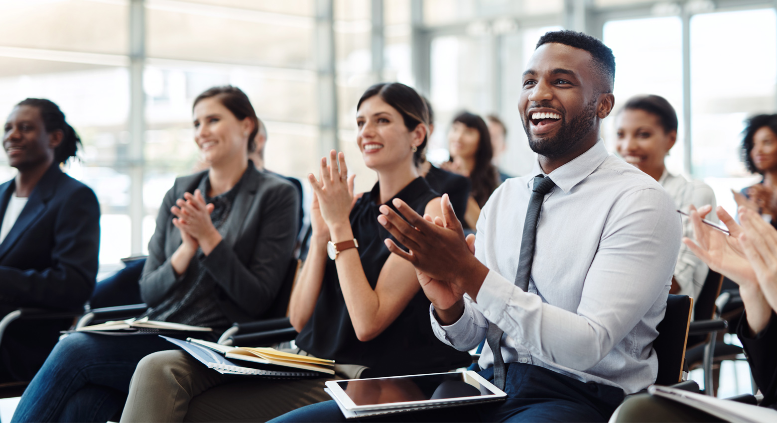 People clapping and smiling in audience 