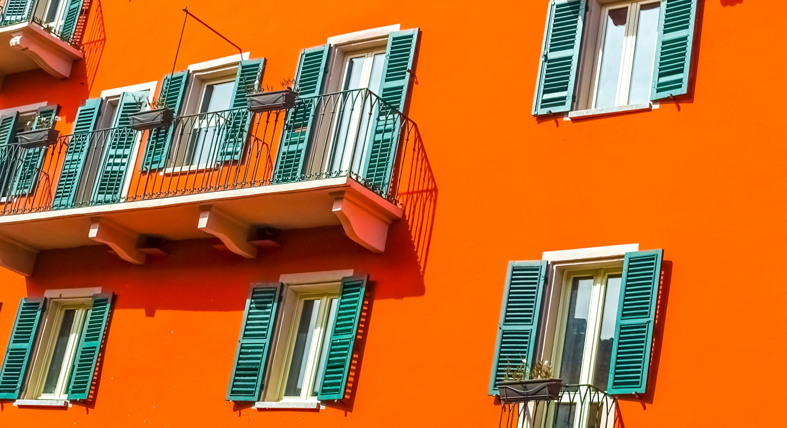 Orange building with turquoise shutters 