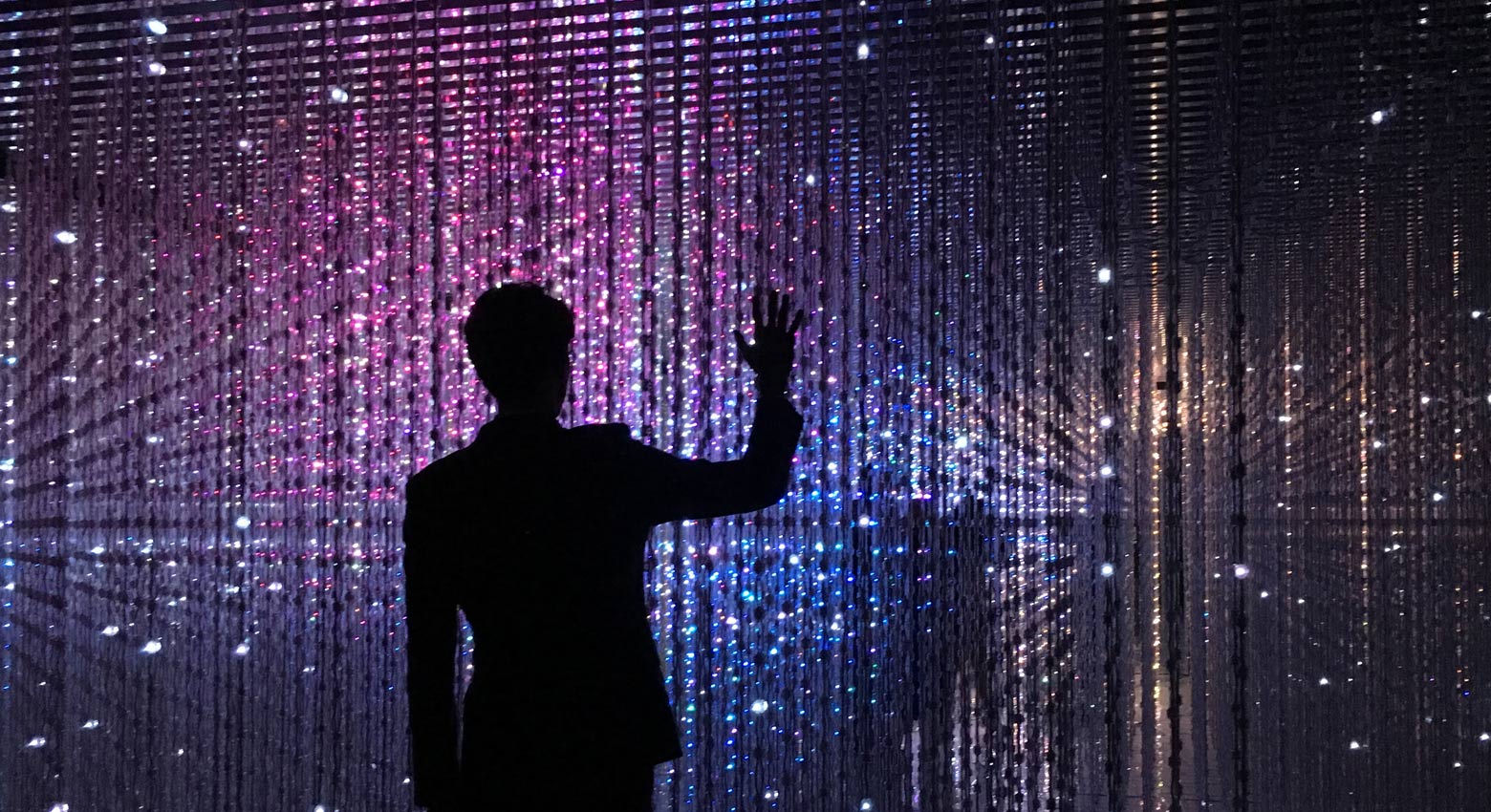 Shadow figure in front of colorful lights 