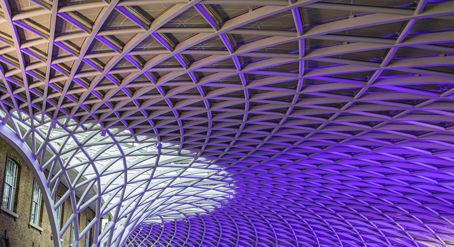 The abstract Kings Cross station ceiling lit up in purple lighting in London seen in May 2022.