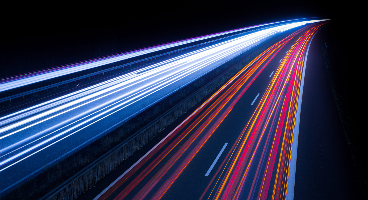 Light Trails On Illuminated City Road At Night