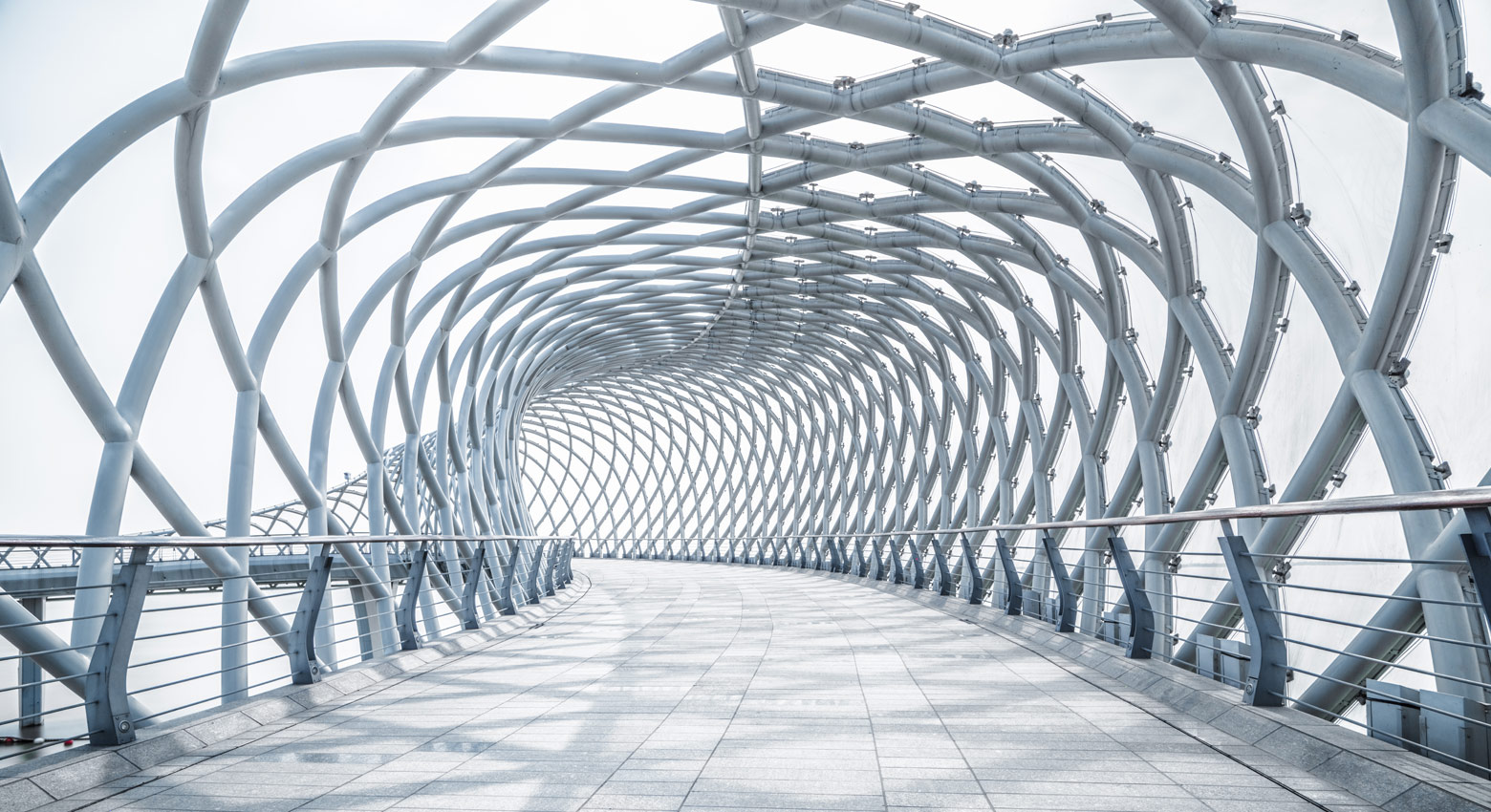 futuristic pedestrian footbridge against sky