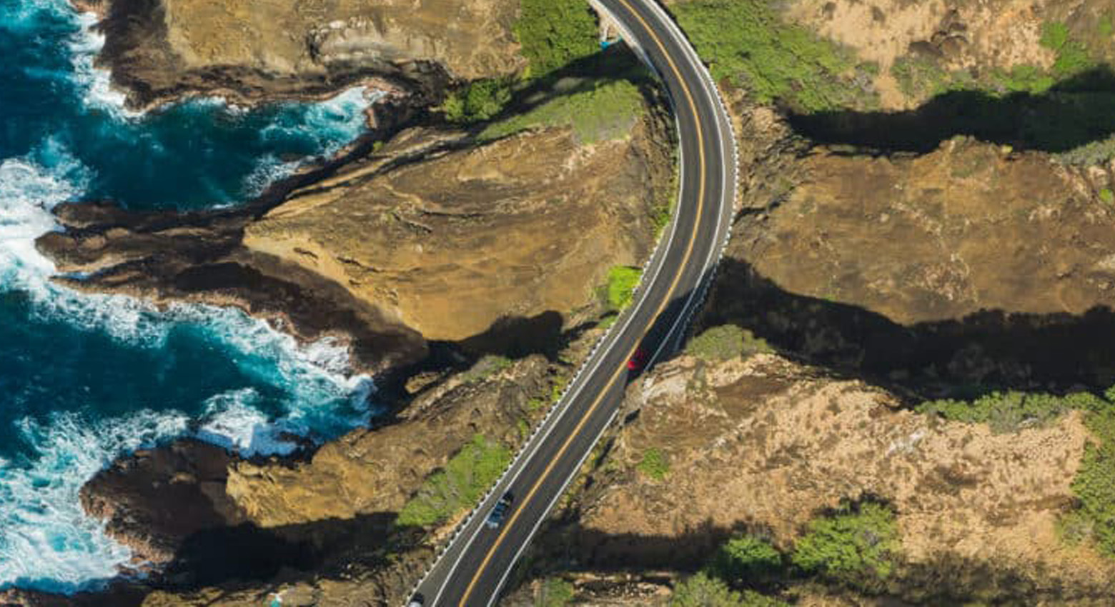 Aerial view of highway, ocean and mountains 