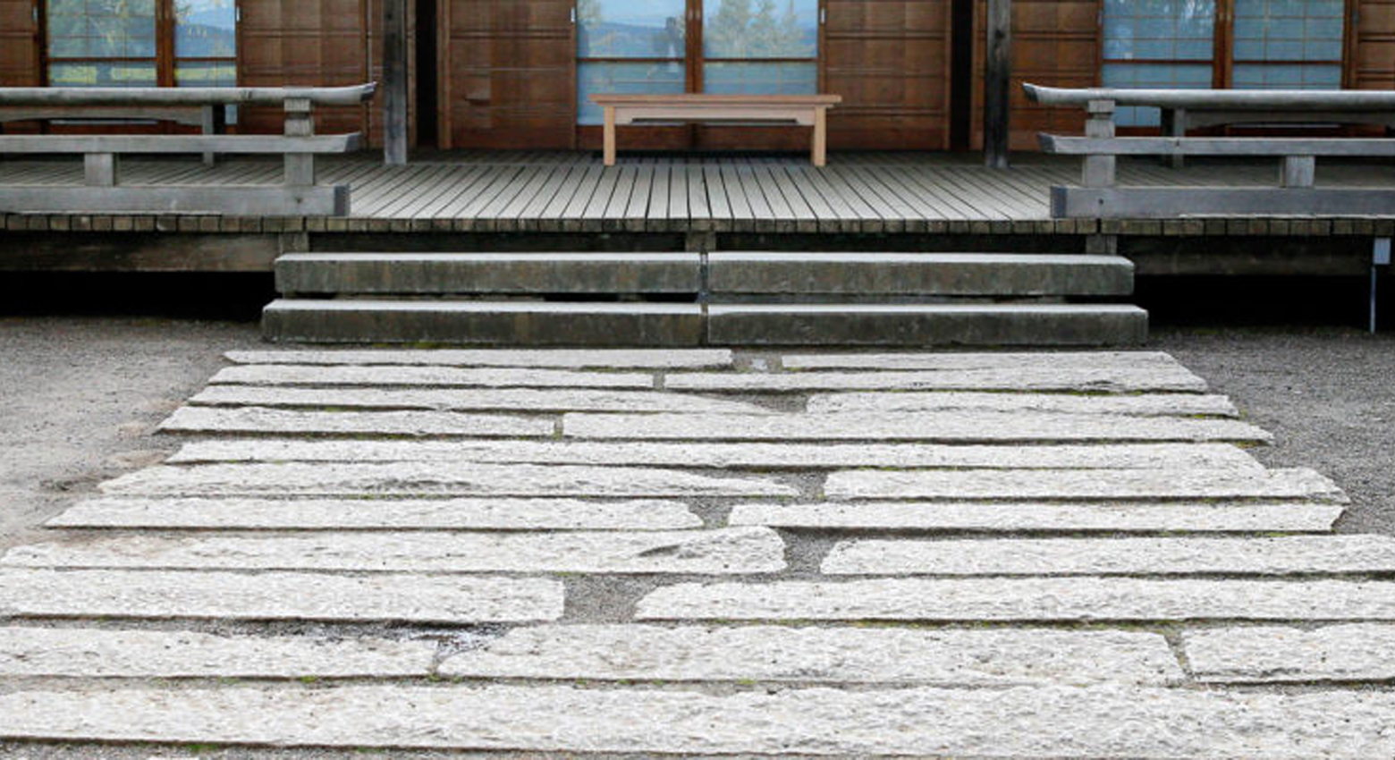 Stone path leading to building and bench 